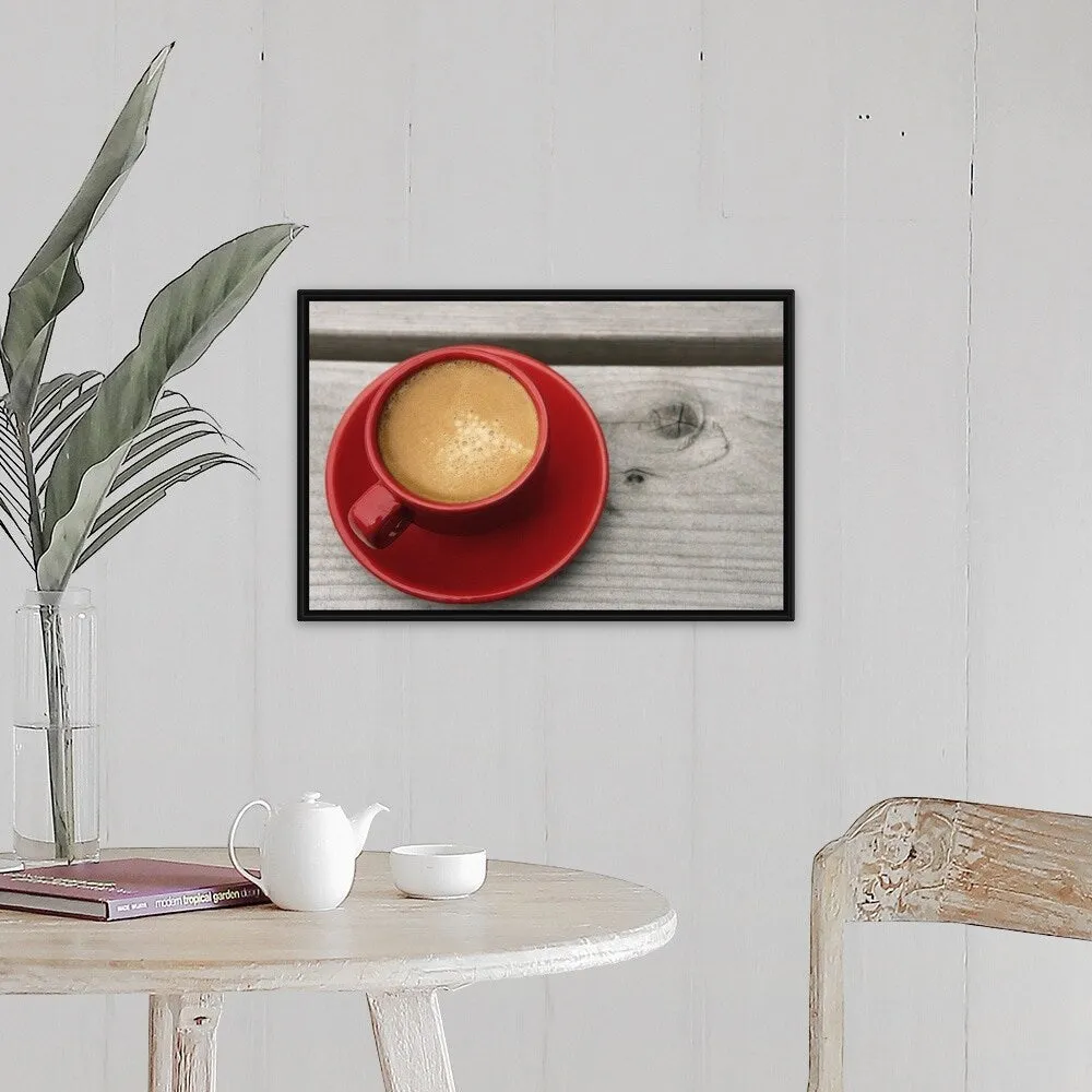 "A bright red cup of espresso coffee on a picnic table outdoors on a summer day." Black Float Frame Canvas Art