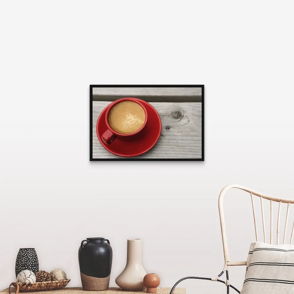 "A bright red cup of espresso coffee on a picnic table outdoors on a summer day." Black Float Frame Canvas Art