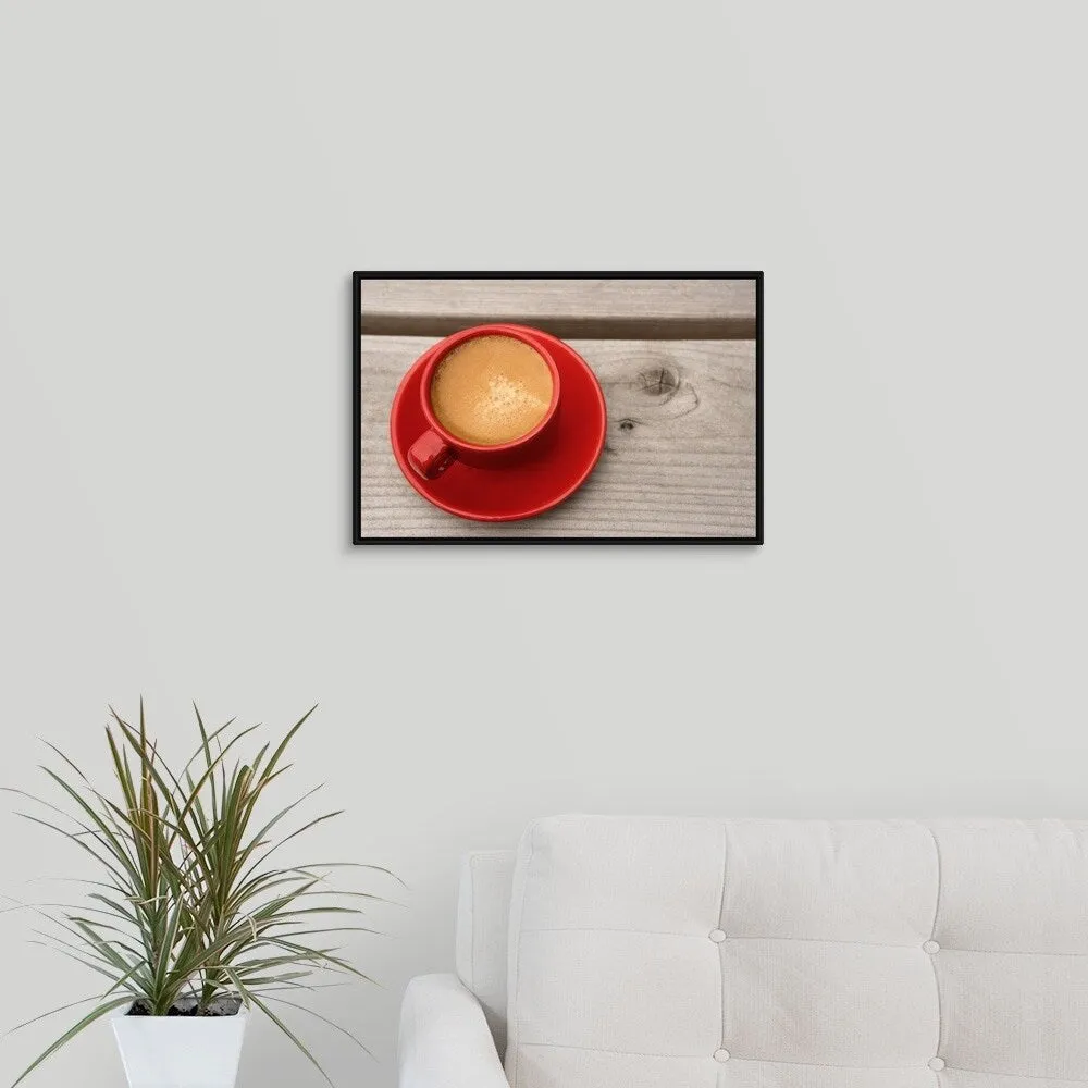 "A bright red cup of espresso coffee on a picnic table outdoors on a summer day." Black Float Frame Canvas Art