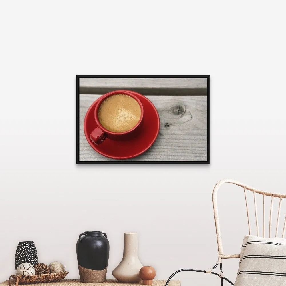 "A bright red cup of espresso coffee on a picnic table outdoors on a summer day." Black Float Frame Canvas Art